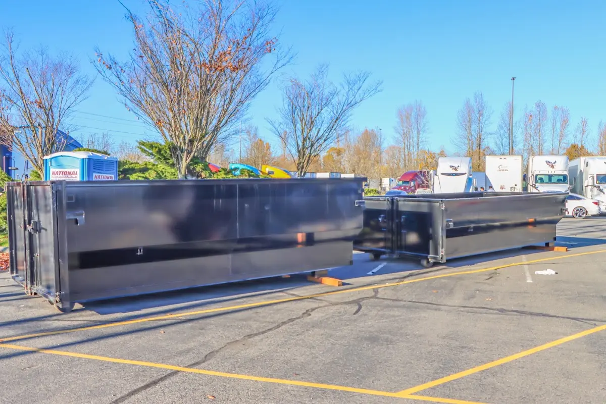 Professional dumpster rental service with roll-off container on residential driveway in Loves Park